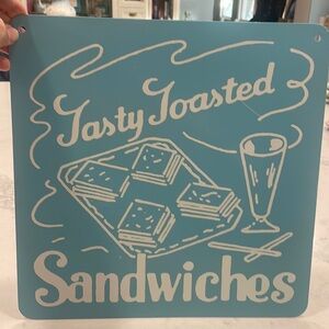 Blue and white tin sandwiches sign